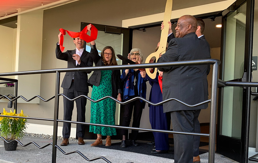 Maurice Lee, Chief Executive Officer of Center Point, Inc., holding scissors, leads Center Point DAAC's ribbon cutting