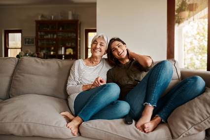 Mom and daughter sitting on a couch.